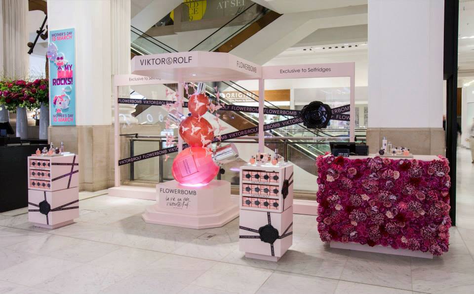 Viktor&Rolf Flowerbomb in-store pop-up display at Selfridges featuring a floral feature wall, product plinths and branded canopy for a temporary retail activation.