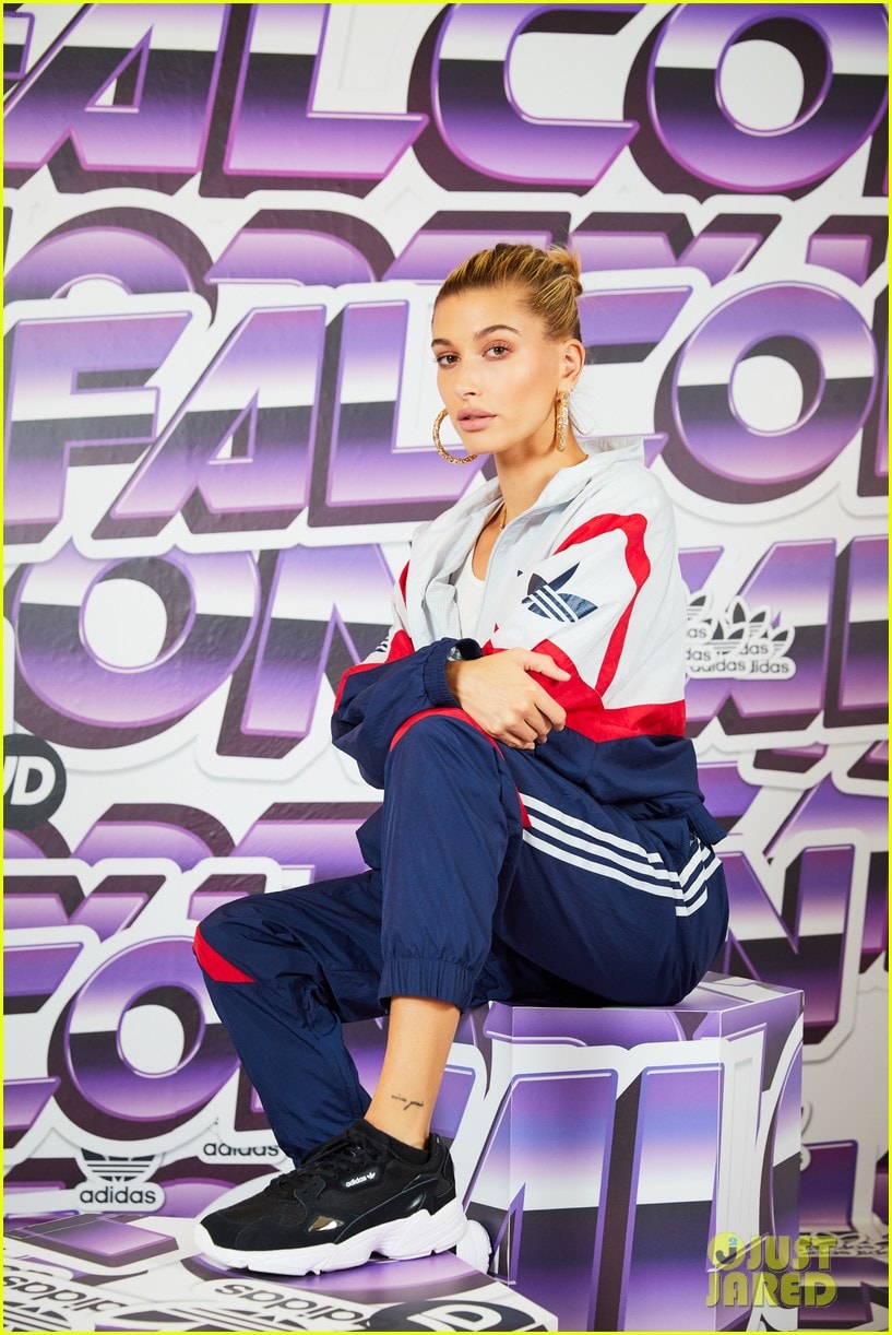 Model posed in front of a purple gradient Adidas branded backdrop with matching printed display cubes, an in-store promotional retail installation.