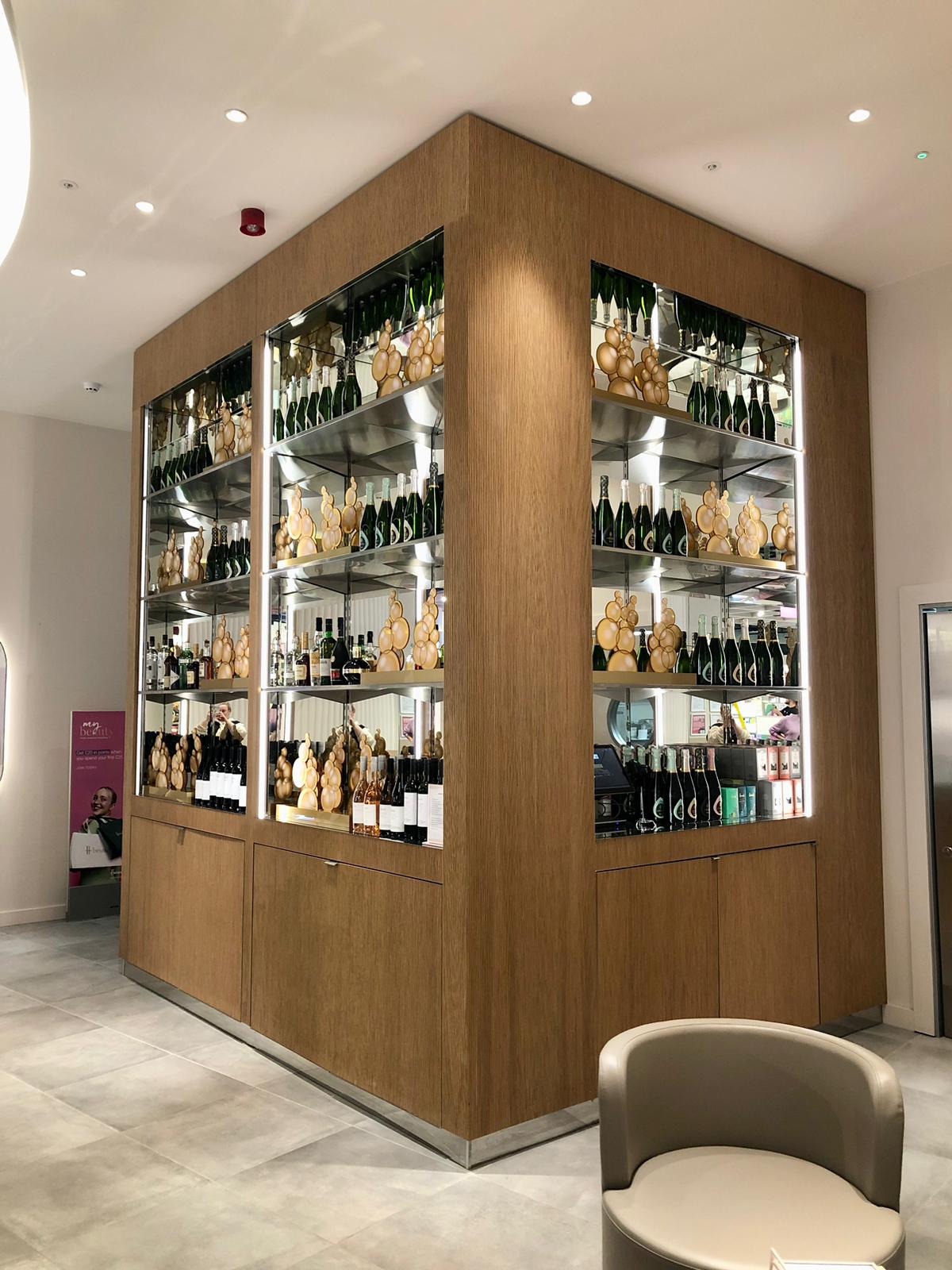 Illuminated champagne shelving display at Harrods